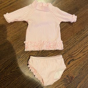 RuffleButts baby pink seersucker rash guard bikini